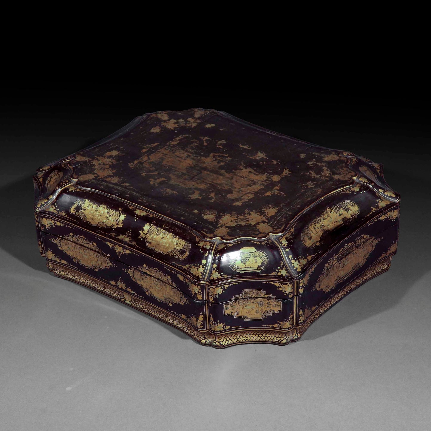 An early 19th century chinoiserie black lacquer box with gilt decoration.