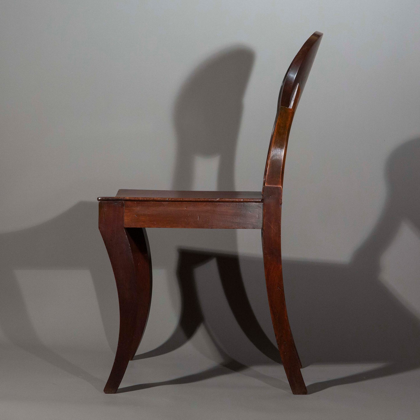 Early 19th Century Pair of Regency Klismos Hall Chairs with Armorial Backs