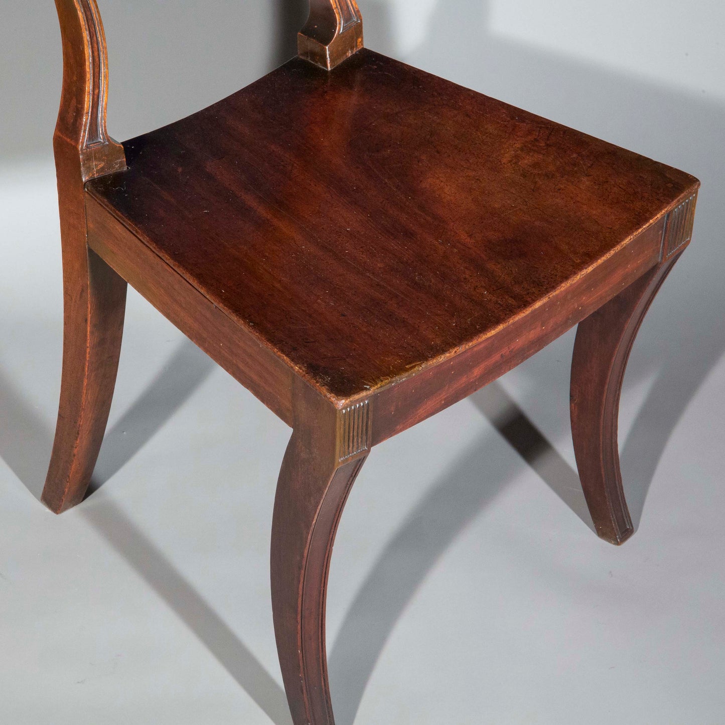 Early 19th Century Pair of Regency Klismos Hall Chairs with Armorial Backs