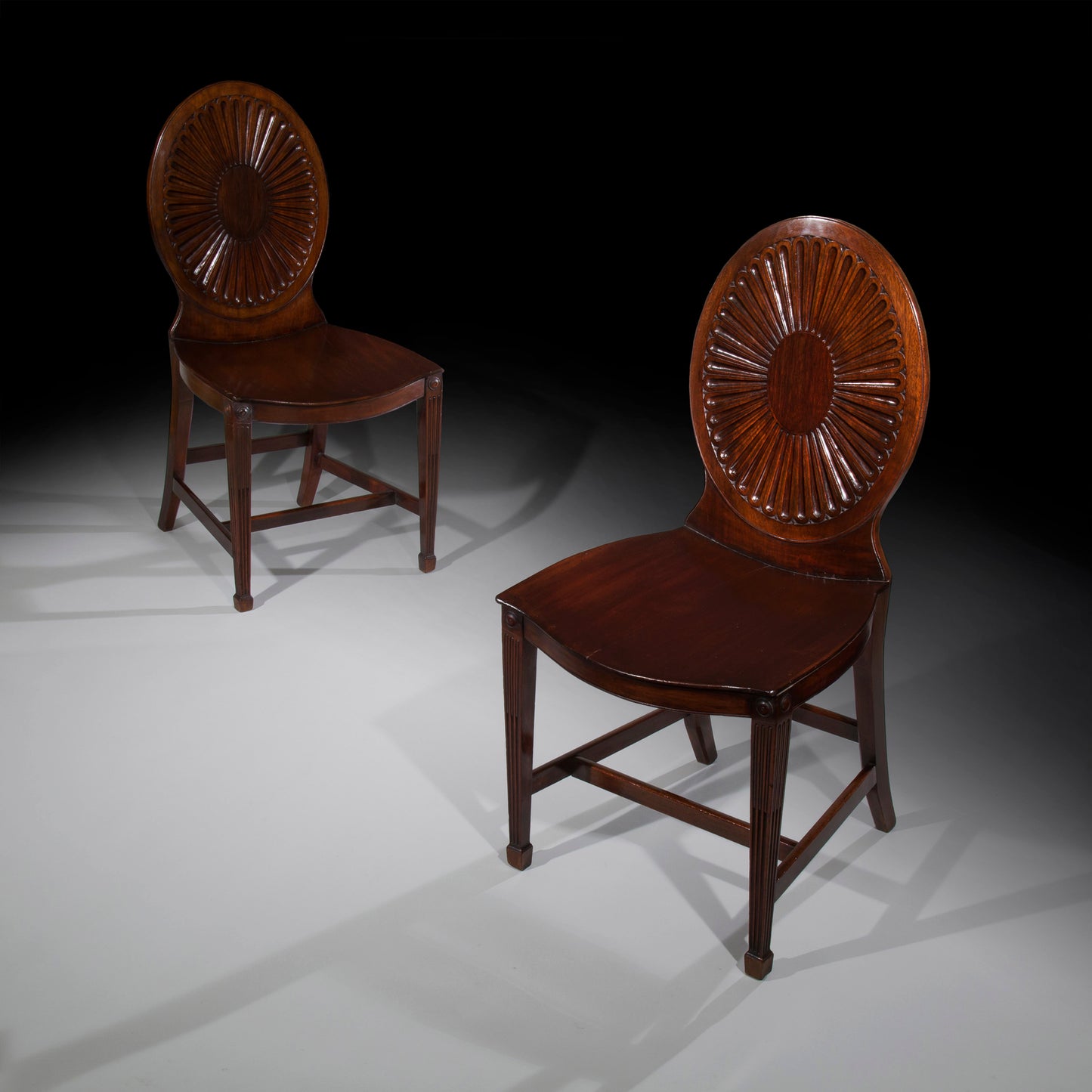 Pair Of George III Hall Chairs, manner of Mayhew and Ince