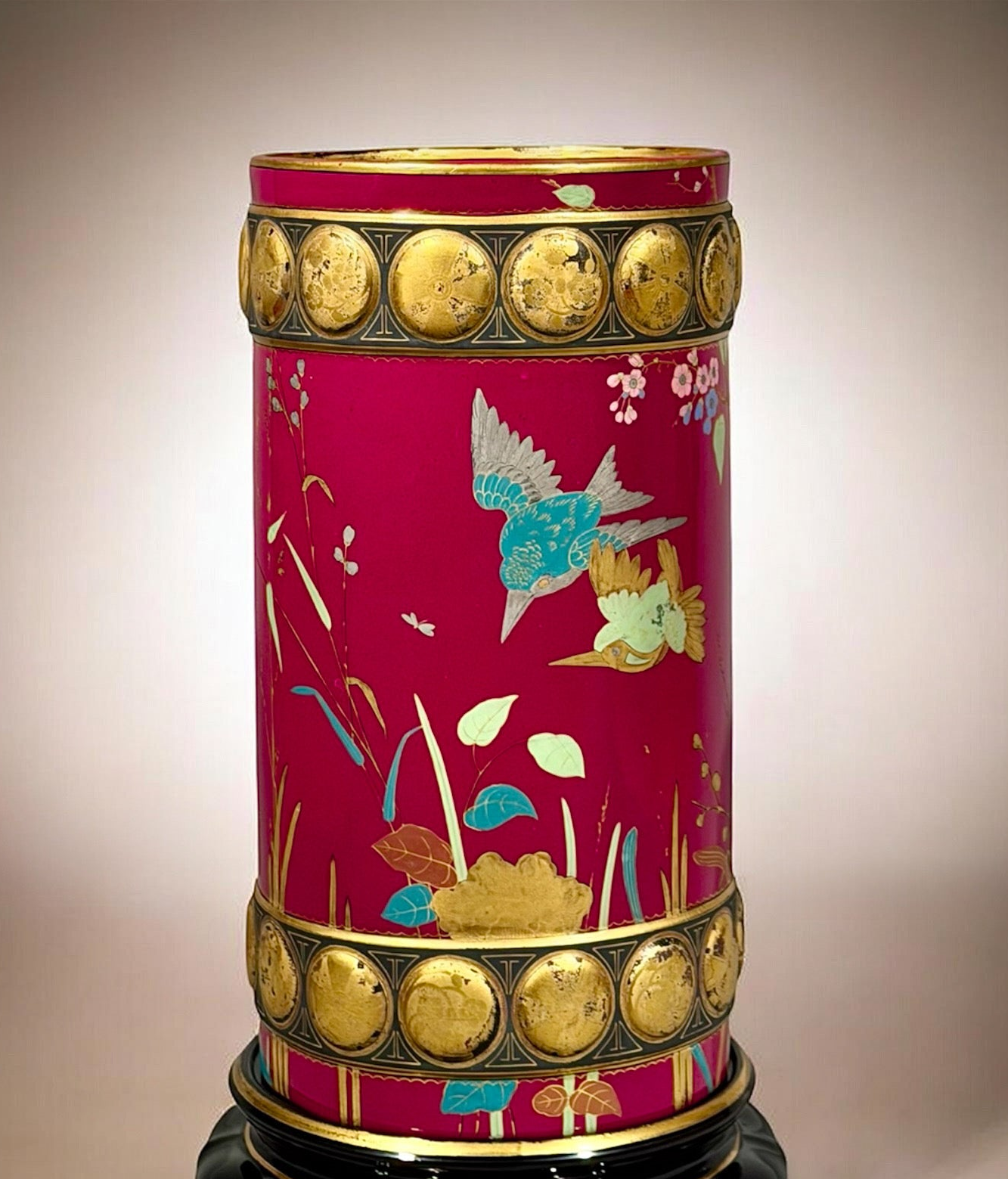 Decorative vase with floral patterns and gold accents on a beige background