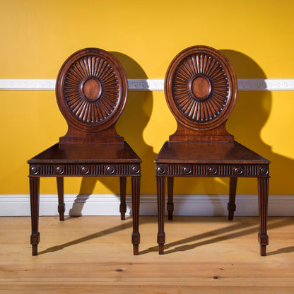 Pair of George III Hall Chairs, attributed to Mayhew and Ince